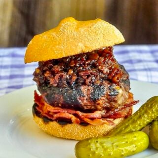 White Cheddar Burgers with beer and bacon jam photo on a white plate with pickles