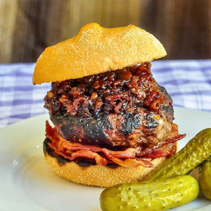White Cheddar Burgers with beer and bacon jam photo on a white plate with pickles