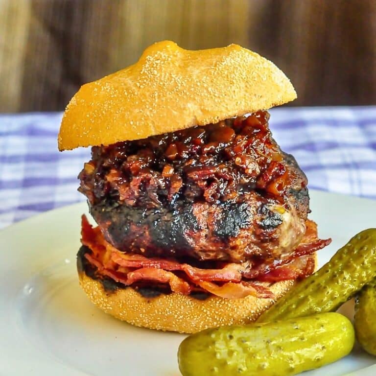 White Cheddar Burgers with beer and bacon jam photo on a white plate with pickles