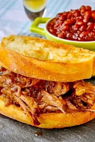 Apple Barbecue Pulled Pork Sandwich shown with homemade baked beans