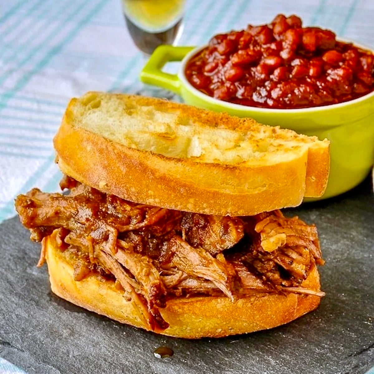 Apple Barbecue Pulled Pork Sandwich shown with homemade baked beans