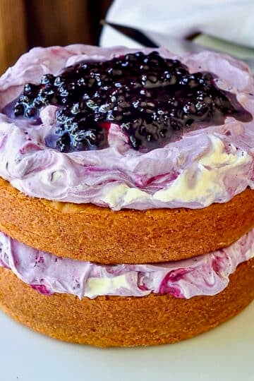 Blueberry Fool Butter Cake photo of uncut completed cake on a white cake plate