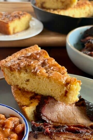 Photo of Sweet Brown Sugar Skillet Cornbread pictured with a smoked brisket dinner for Google featured image.