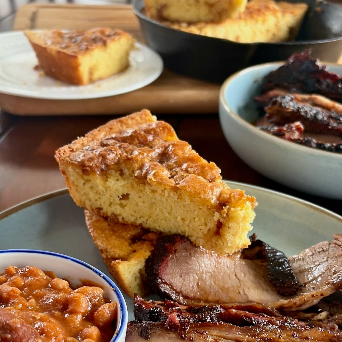 Photo of Sweet Brown Sugar Skillet Cornbread pictured with a smoked brisket dinner for Google featured image.