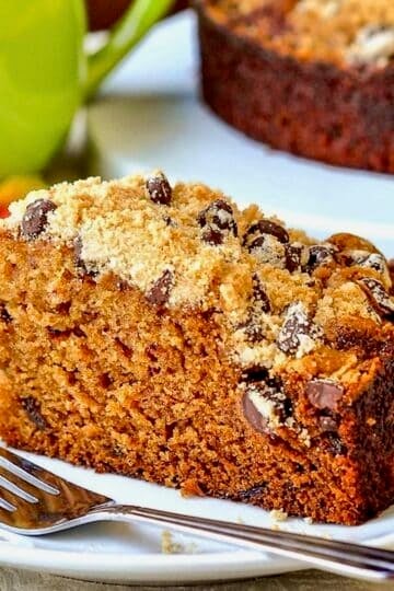 Date Coffee Cake with Chocolate Chip Streusel photo of single slice on a white plate for featured image.