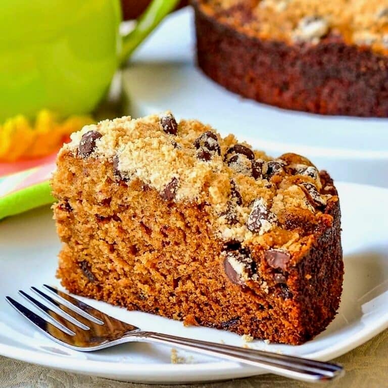 Date Coffee Cake with Chocolate Chip Streusel photo of single slice on a white plate for featured image.
