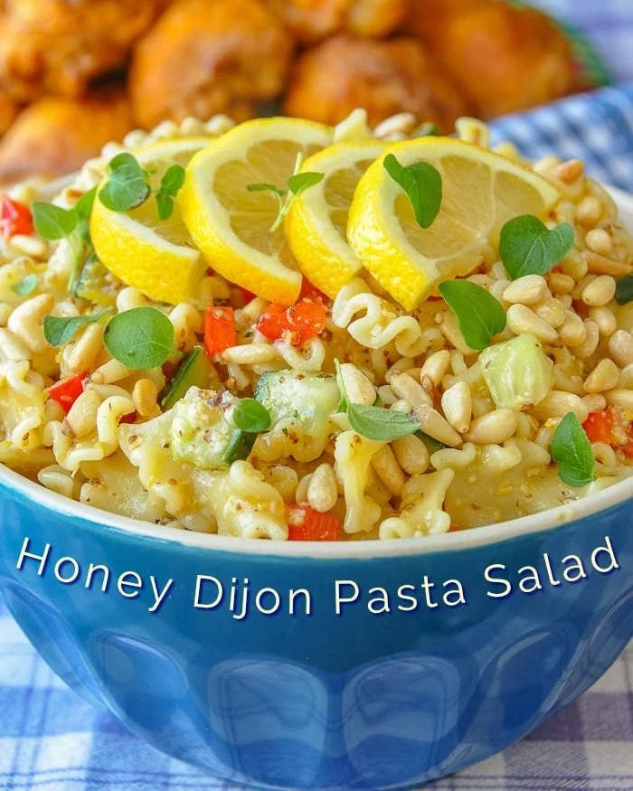 Honey Dijon Pasta Salad square crop photo in a blue bowl with title text added for social media posts.