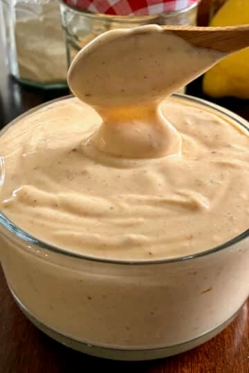 Better than Miracle Whip with a wooden spoon shown to serve the dressing.