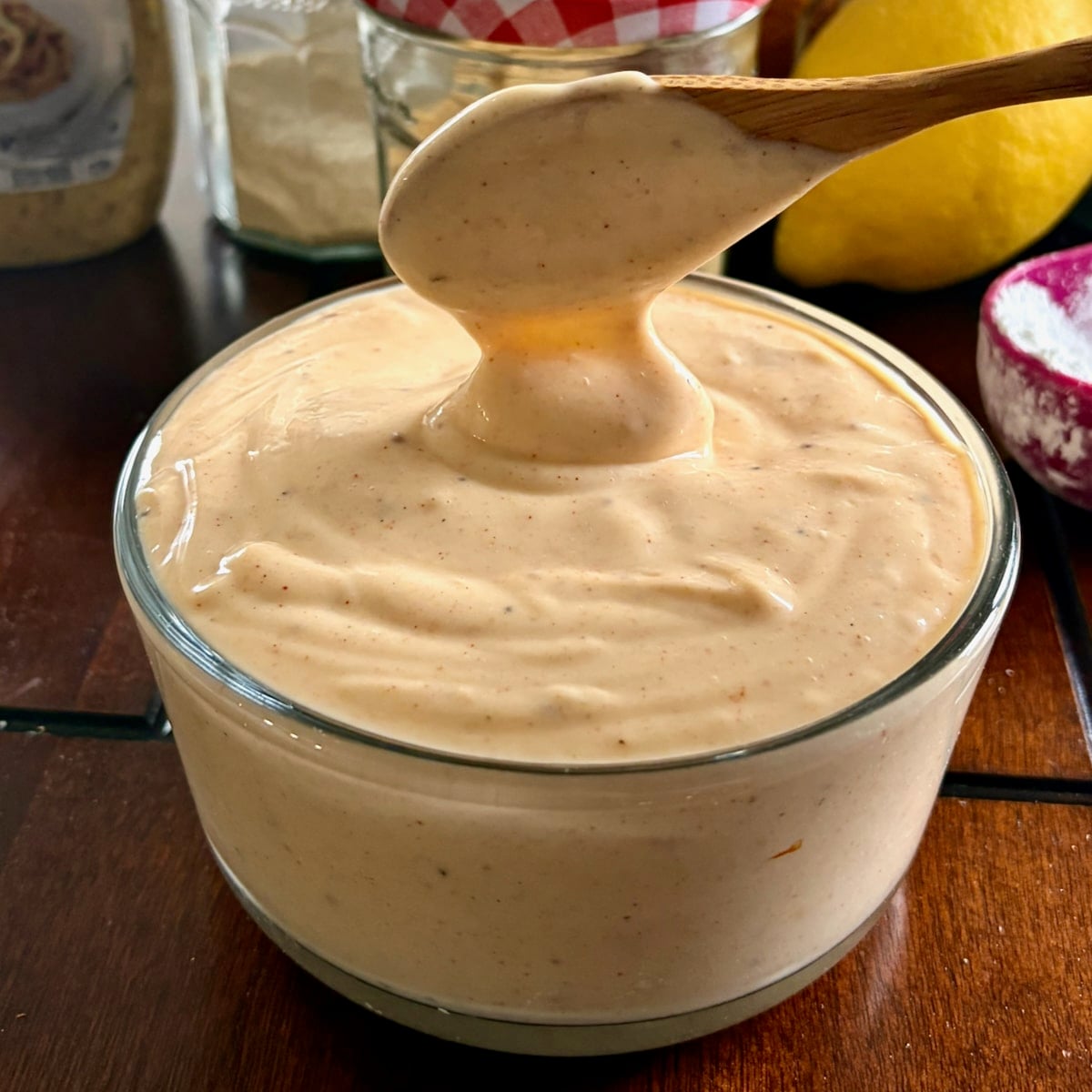 Better than Miracle Whip with a wooden spoon shown to serve the dressing.