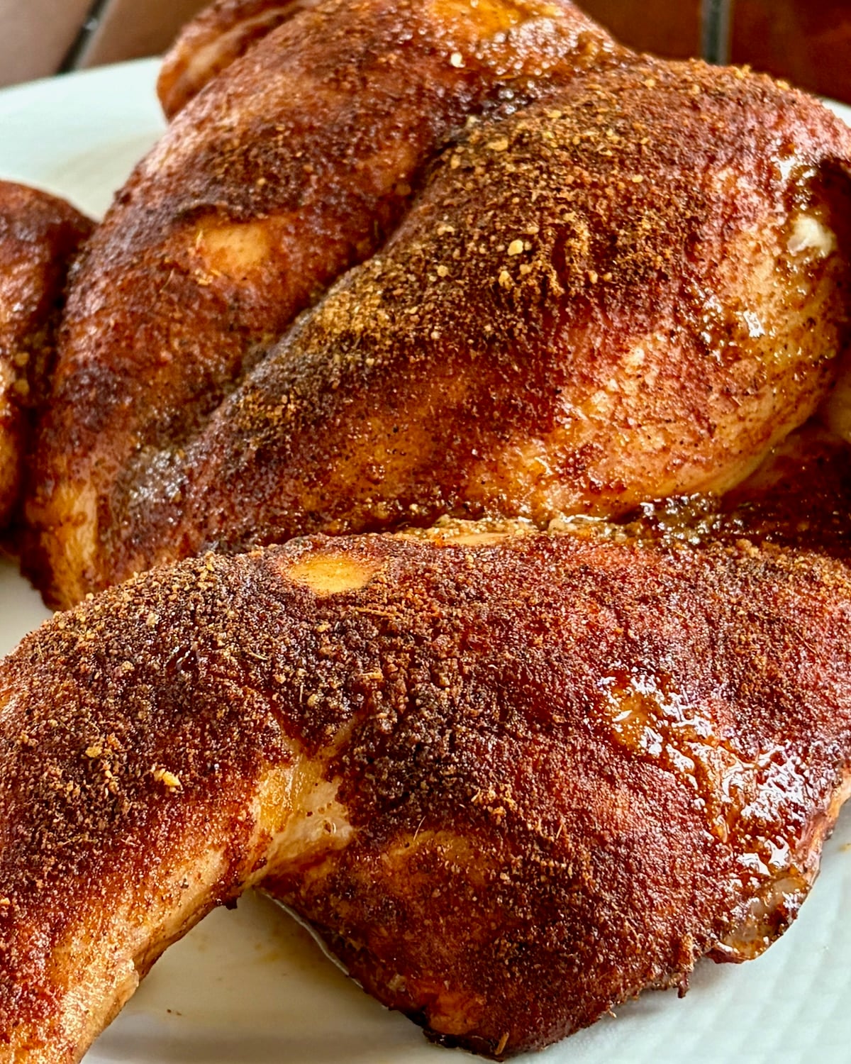 Close up photo of Smoky Summer Barbecue Chicken Spice on cookd chicken skin