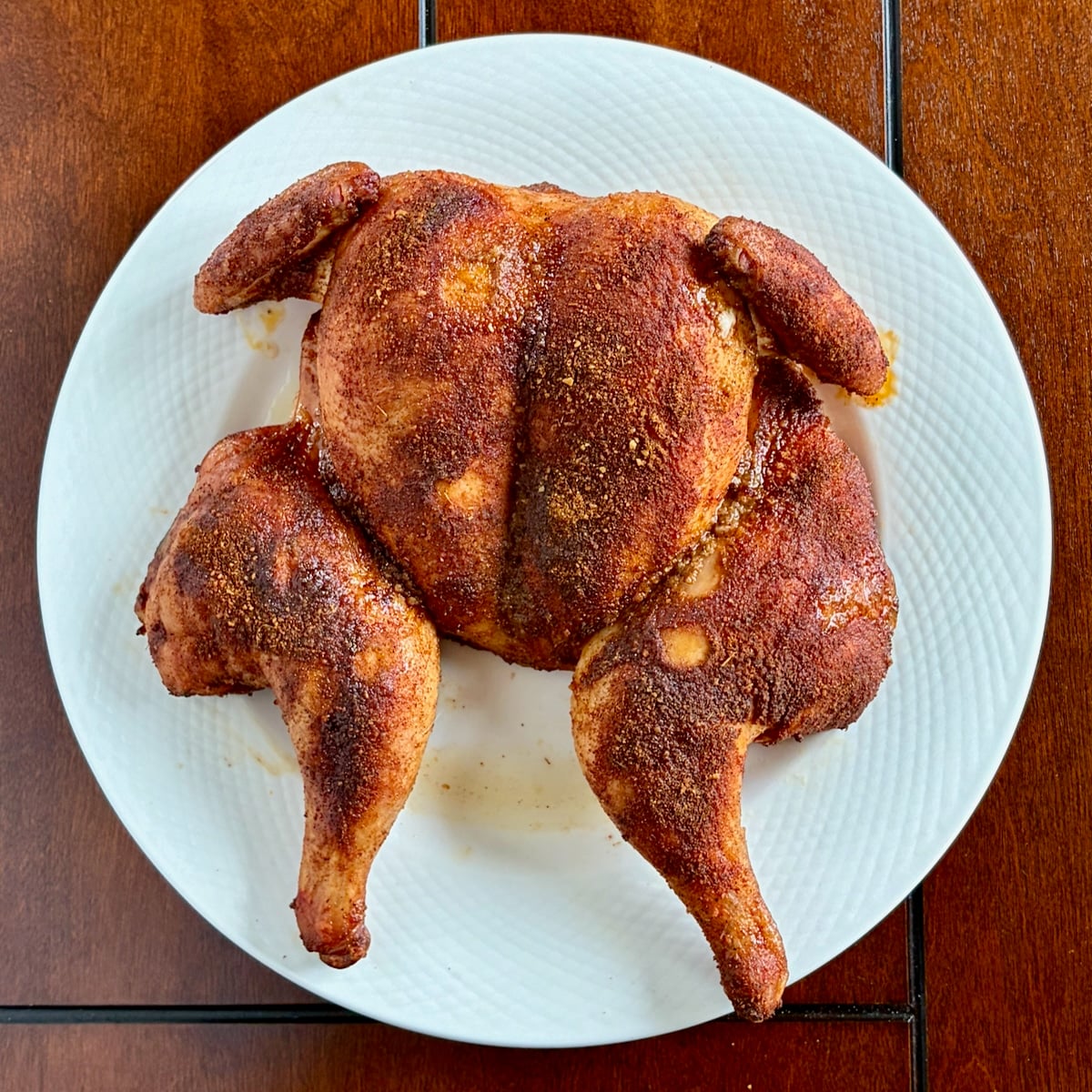 Overhead photo of a spatchcocked chicken with Smoky Summer Barbecue Chicken Spice