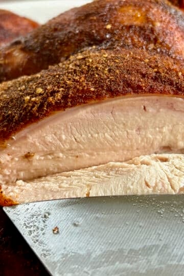 Smoky Summer Barbecue Chicken Spice photo of a smoked chicken being carved to show juicy breast meat.