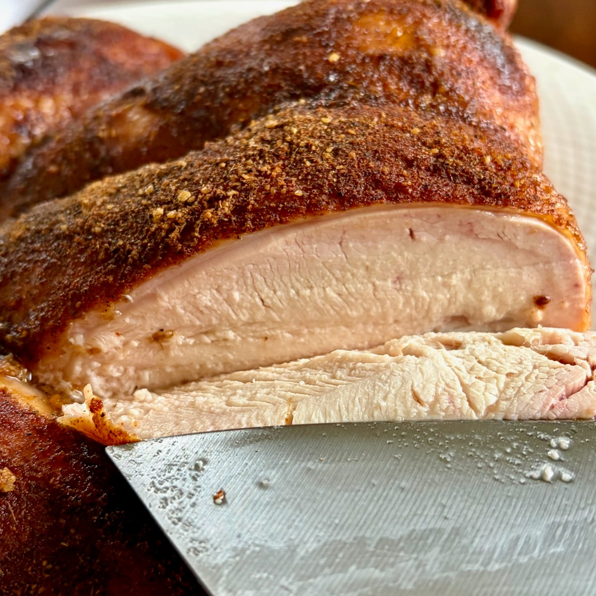 Smoky Summer Barbecue Chicken Spice photo of a smoked chicken being carved to show juicy breast meat.