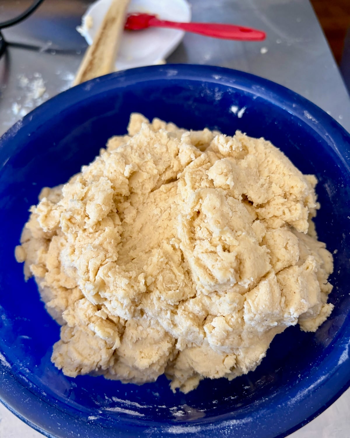 Photo of finished sour cream donut dough in a blue Bowl.