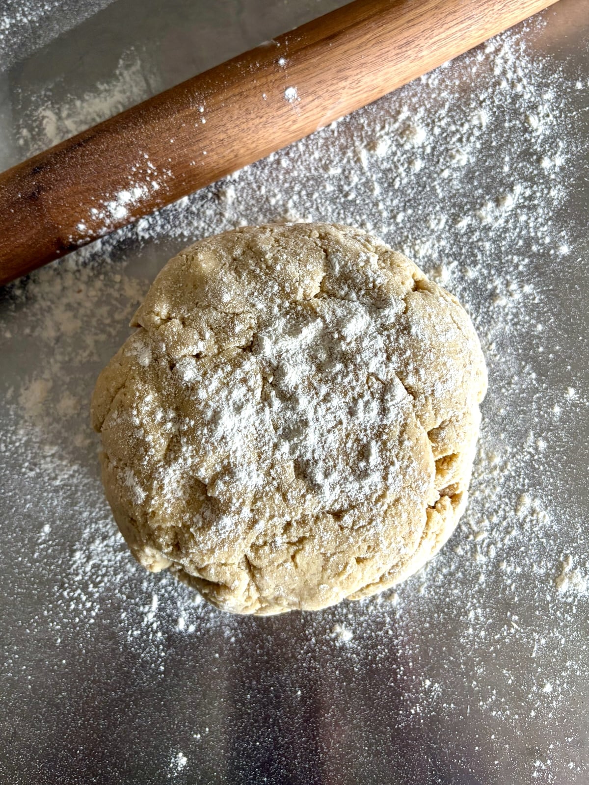 Photo of sour cream donut dough ready to be rolled on a stainless steel worktop