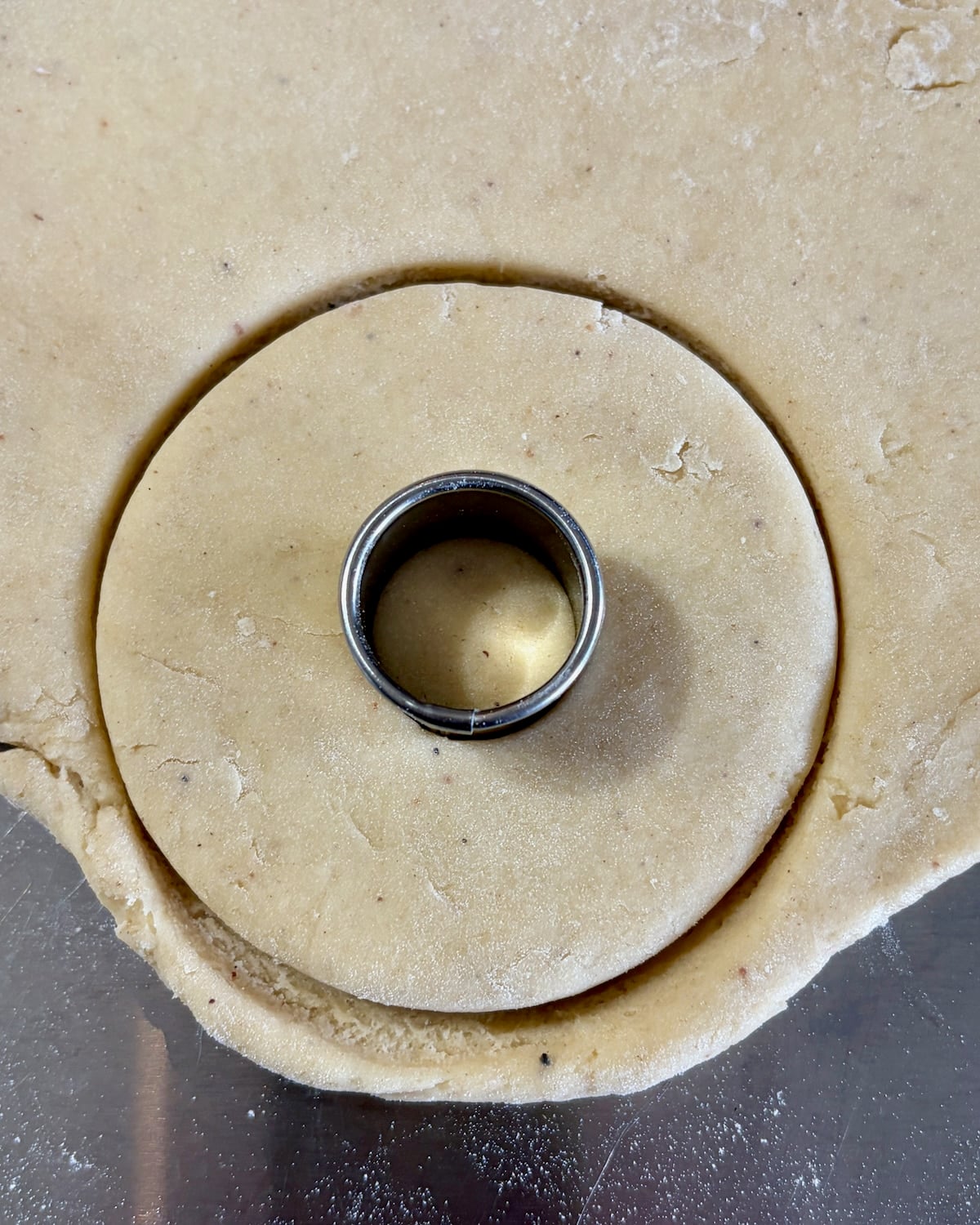 Photo of donuts being cut out of rolled dough.