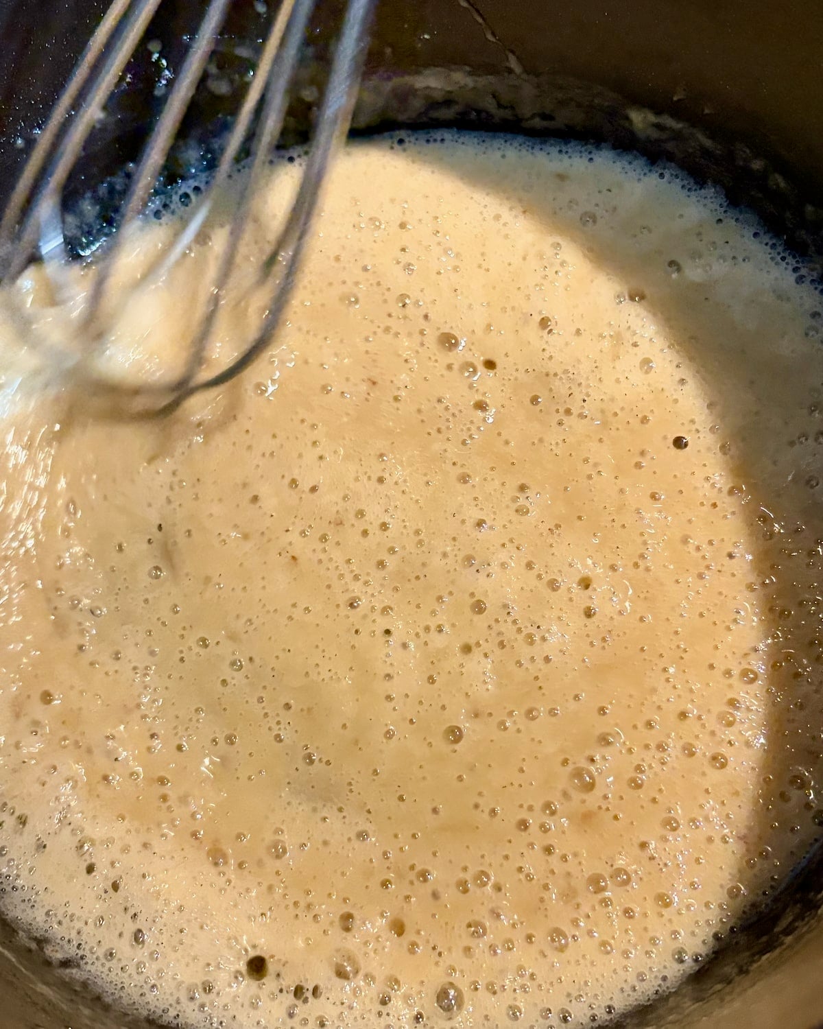 When the roux gets quite foamy is the time to start adding the chicken stock. photo of that stage.