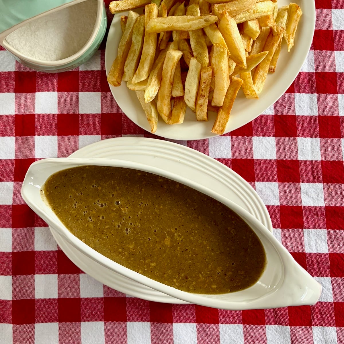 overhead photo of chicken skin gravy in a white gravy boat