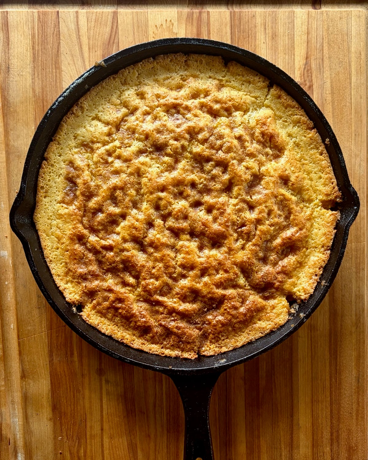 Photo of baked cornbread in a skillet.