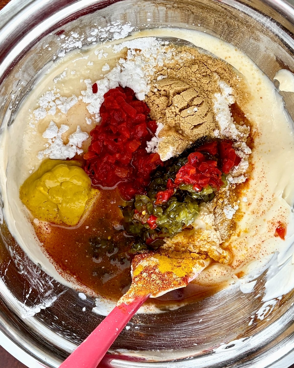 Ingredients for sandwich spread in a stainless steel bowl unstirred