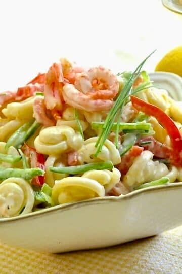 Lemon Shrimp Pasta Salad shown in a square white serving bowl.