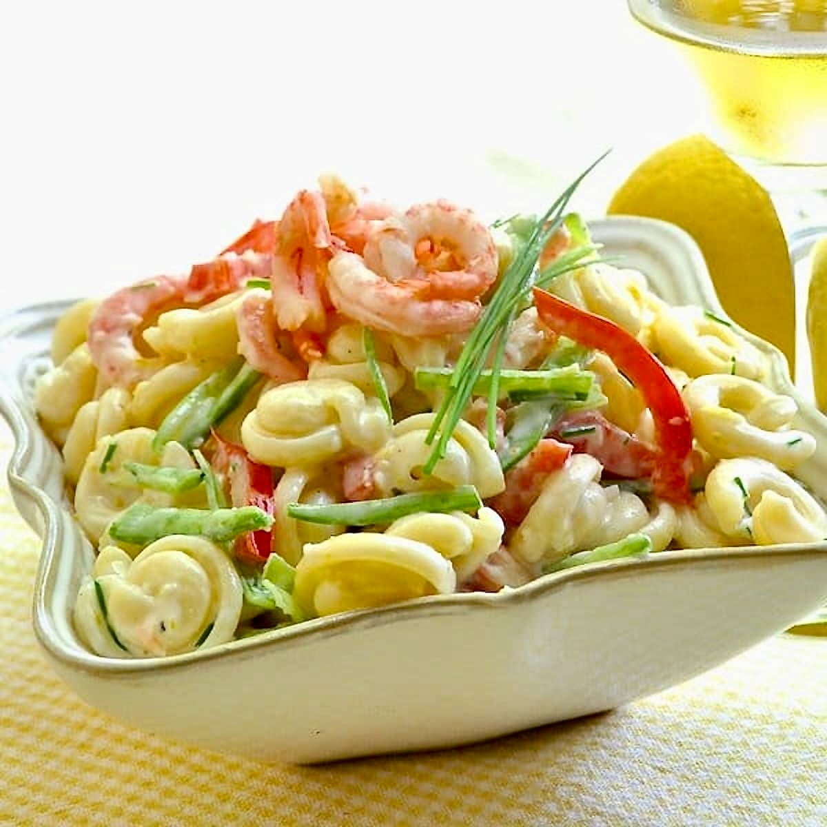 Lemon Shrimp Pasta Salad shown in a square white serving bowl.