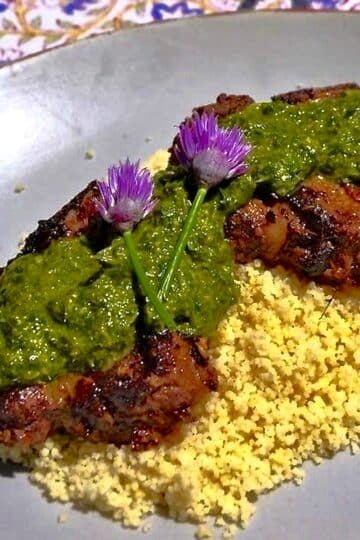 Moroccan Lamb Chops with Chermoula Sauce photo if finished dish in a bed of couscous,