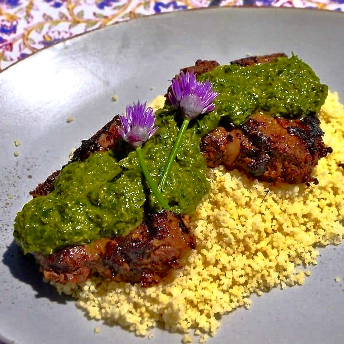 Moroccan Lamb Chops with Chermoula Sauce photo if finished dish in a bed of couscous,