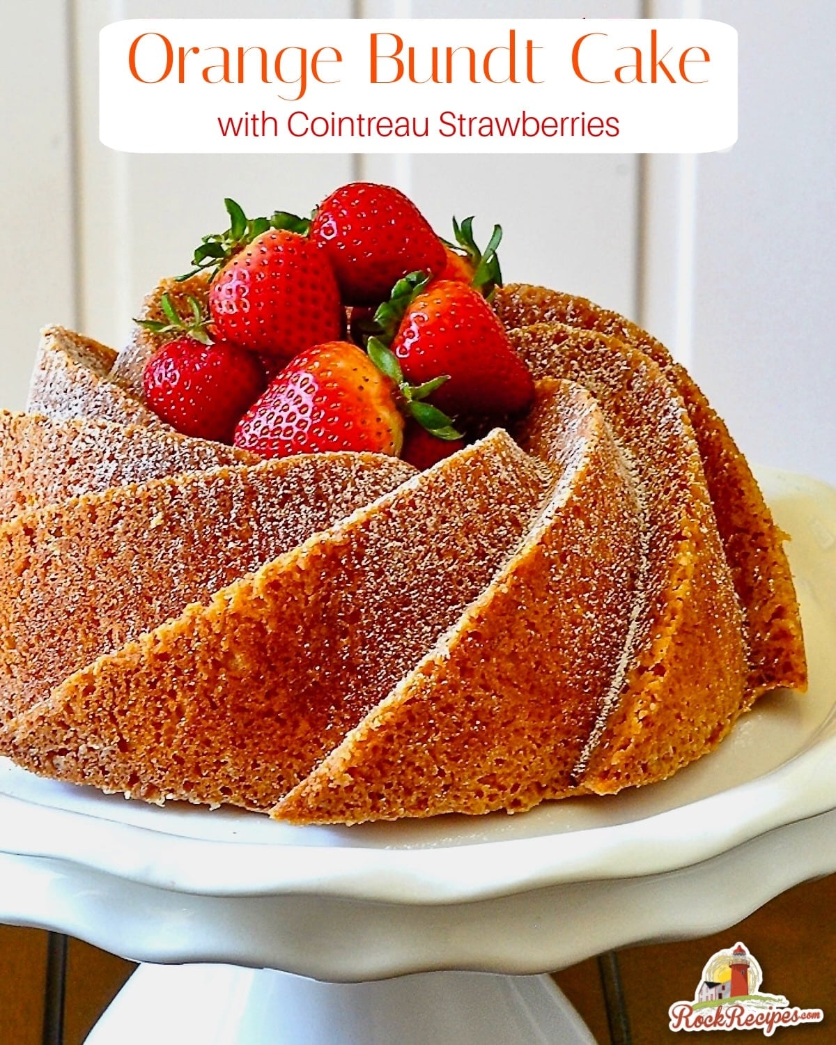 Orange Bundt Cake uncut on a white pedestal stand with title text added for Pinterest and social media posts.