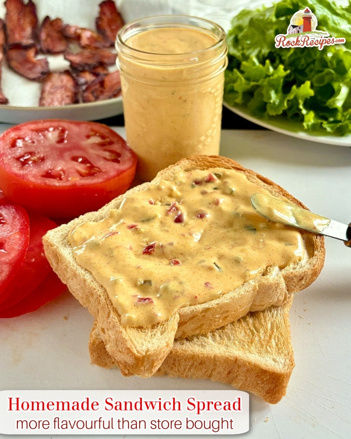 Photo of sandwich spread on toasted bread for a BLT with title text and logo added for social media posts