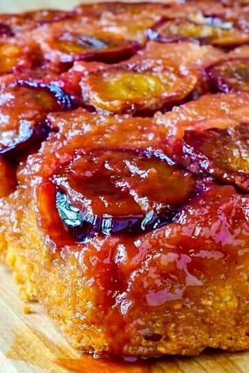 Close up photo of uncut plum cake for Google featured image.