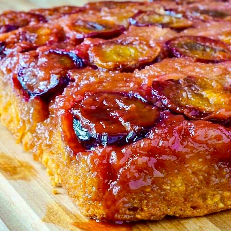 Close up photo of uncut plum cake for Google featured image.