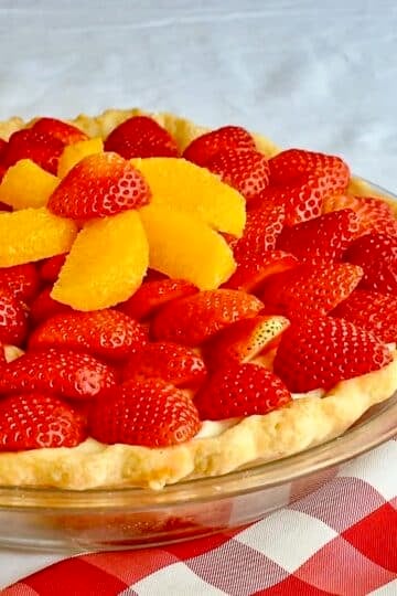 White Chocolate Mousse Pie with Orange and Strawberry close up photo of uncut pie.