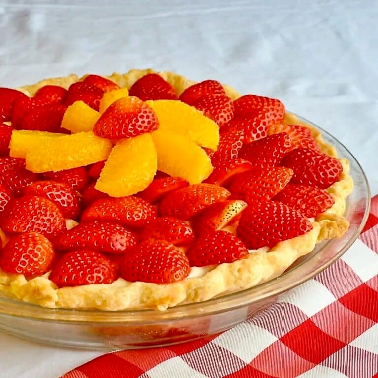 White Chocolate Mousse Pie with Orange and Strawberry close up photo of uncut pie.