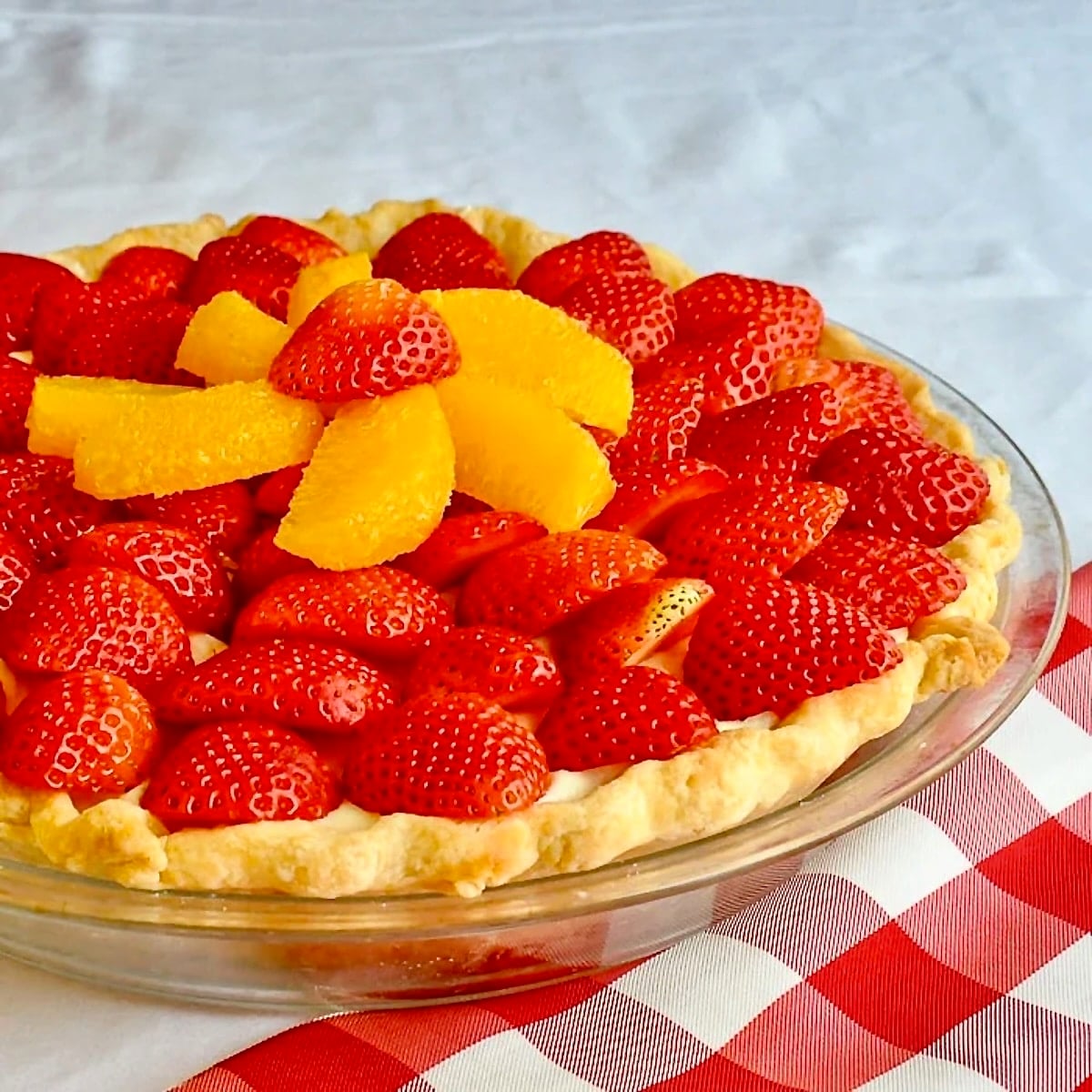 White Chocolate Mousse Pie with Orange and Strawberry close up photo of uncut pie.