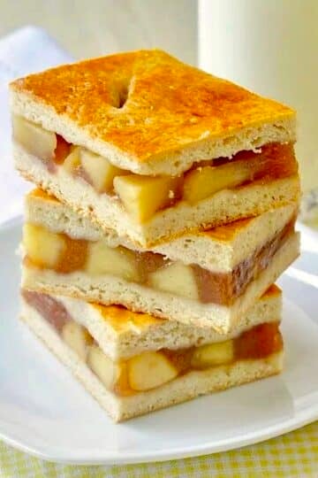 Apple Cobbler Bars stacked on a white plate.