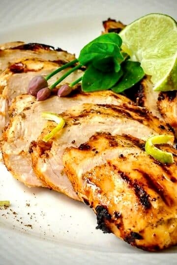 Close up photo of Chili Lime Cumin Grilled Chicken on a white plate.