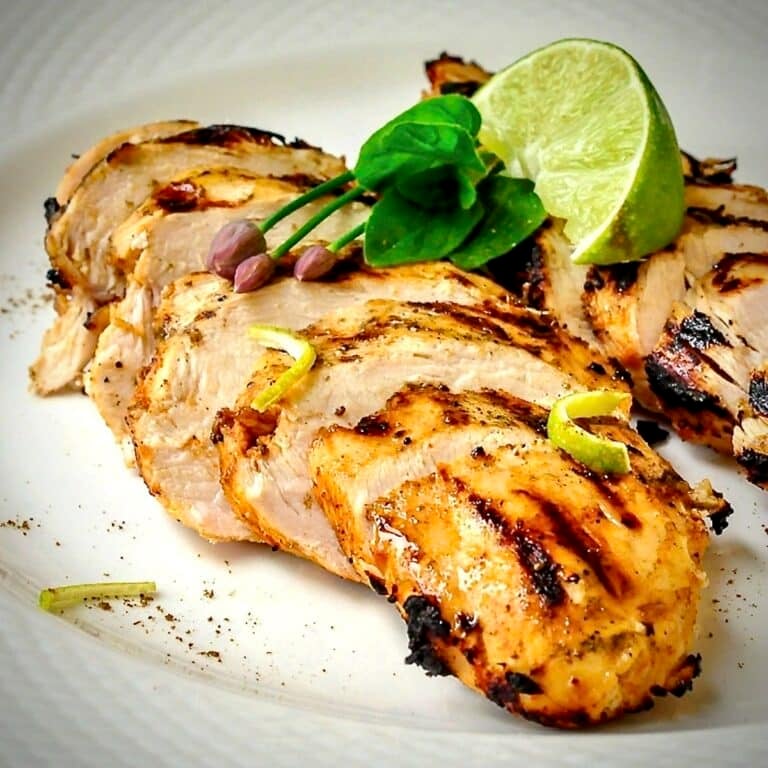 Close up photo of Chili Lime Cumin Grilled Chicken on a white plate.