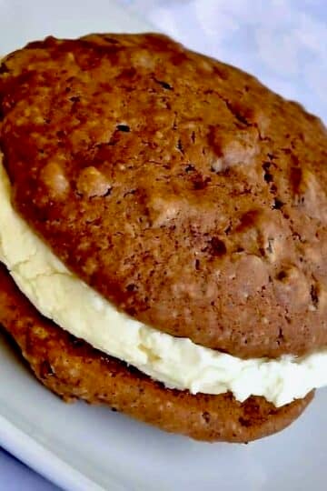 Chocolate Chip Vanilla Cream Whoopie Pies featured image of one serving on a white plate