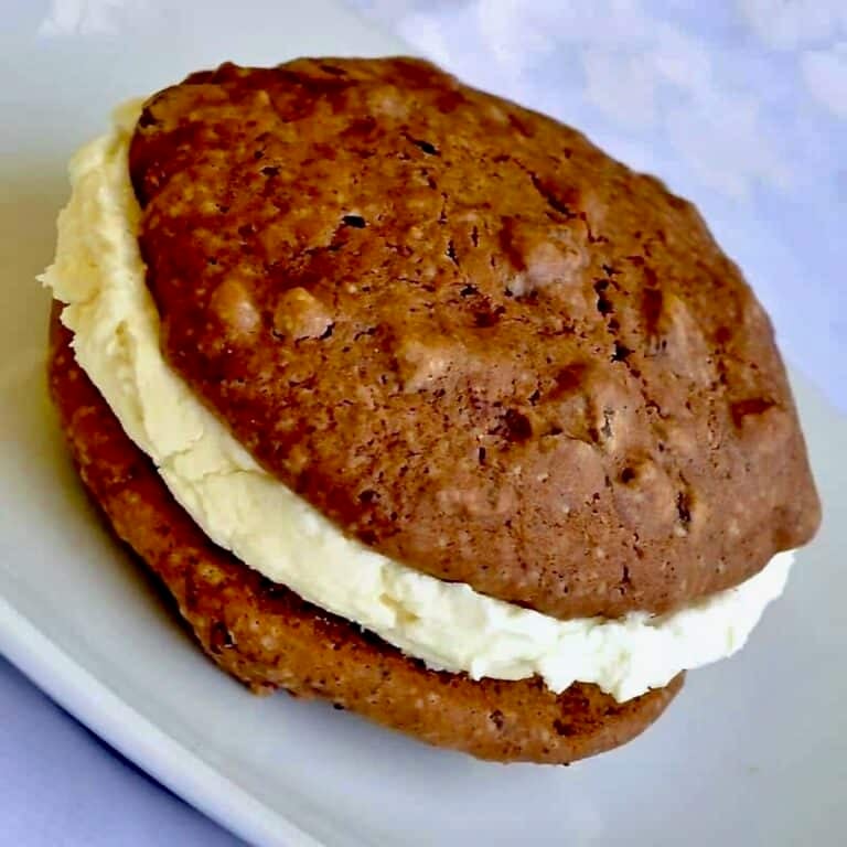 Chocolate Chip Vanilla Cream Whoopie Pies featured image of one serving on a white plate