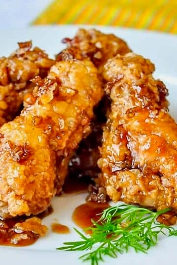 Crispy Honey Garlic Chicken Wings close up photo on a white plate for featured image