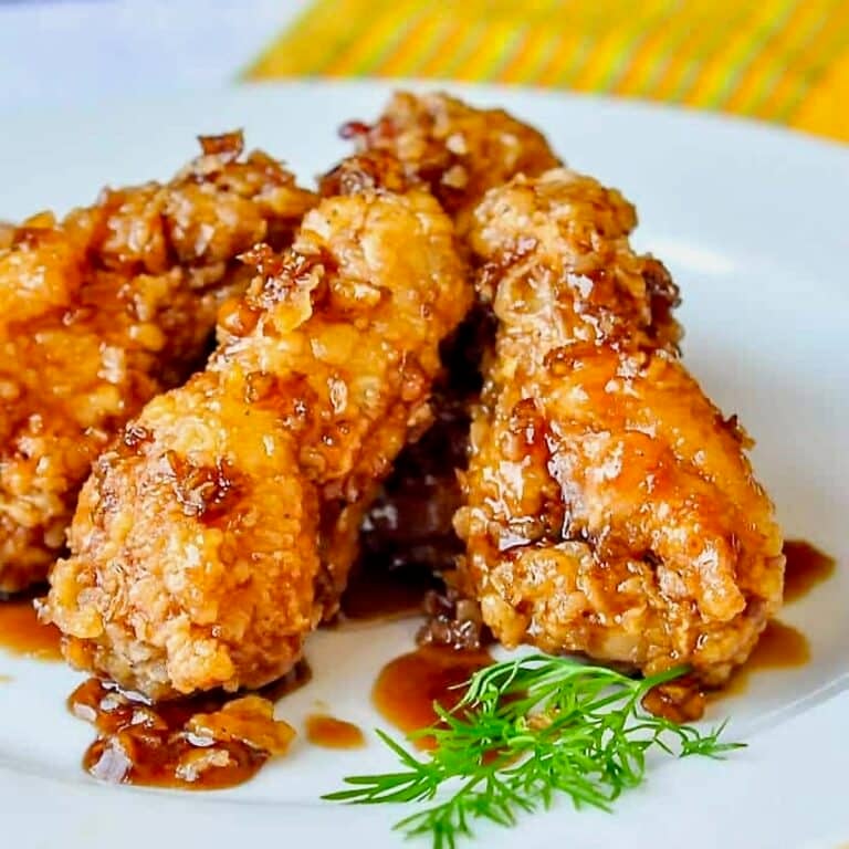 Crispy Honey Garlic Chicken Wings close up photo on a white plate for featured image