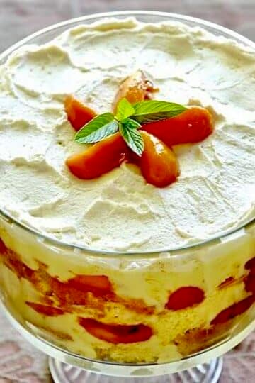Peaches and Cream Trifle in a clear glass trifle bowl pedestal stand.