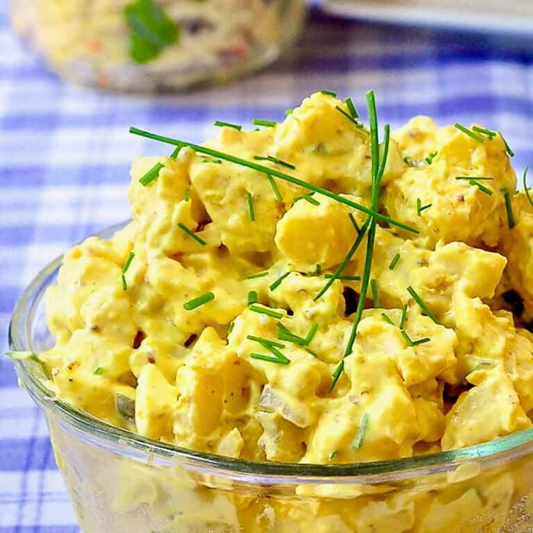 Deviled Egg Potato Salad close up photo of salad in a clear glass bowl