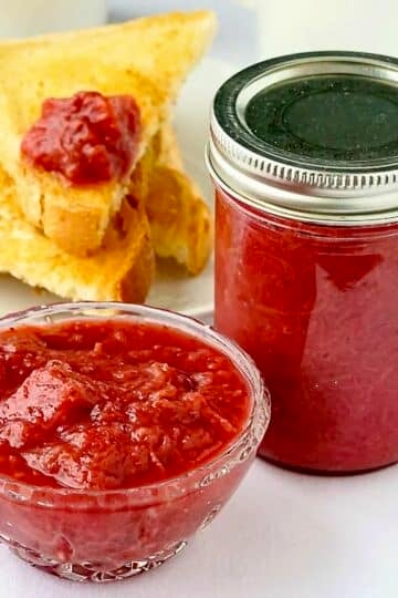 Heavenly Rhubarb Jam in a small serving dish with full mason jar on the side.