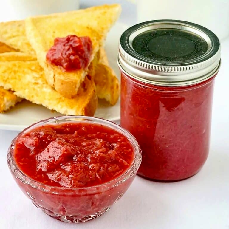 Heavenly Rhubarb Jam in a small serving dish with full mason jar on the side.