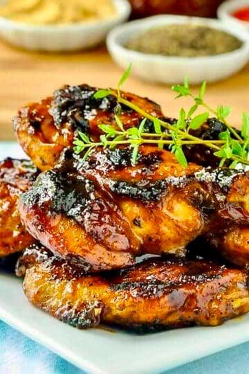 Honey Peach Barbecue Sauce on Grilled Wings close up photo of wings stacked in a white plate.