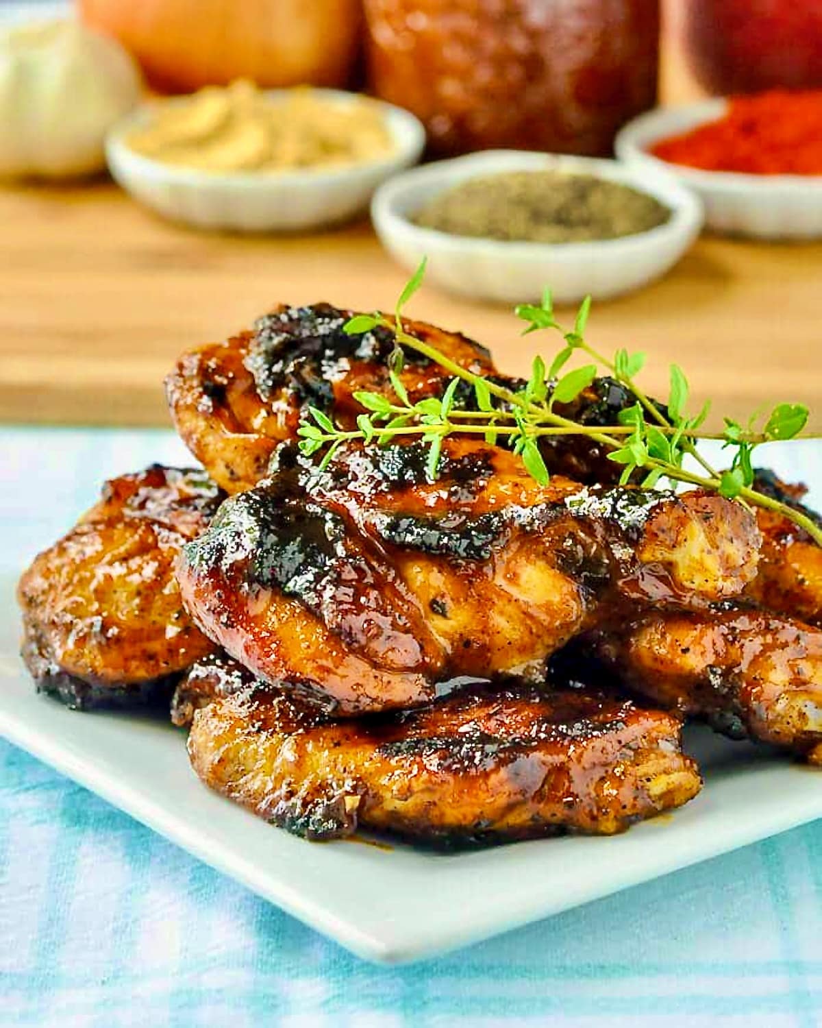 Photo of Honey Peach Barbecue Sauce on Grilled Wings with recipe ingredients in th background.