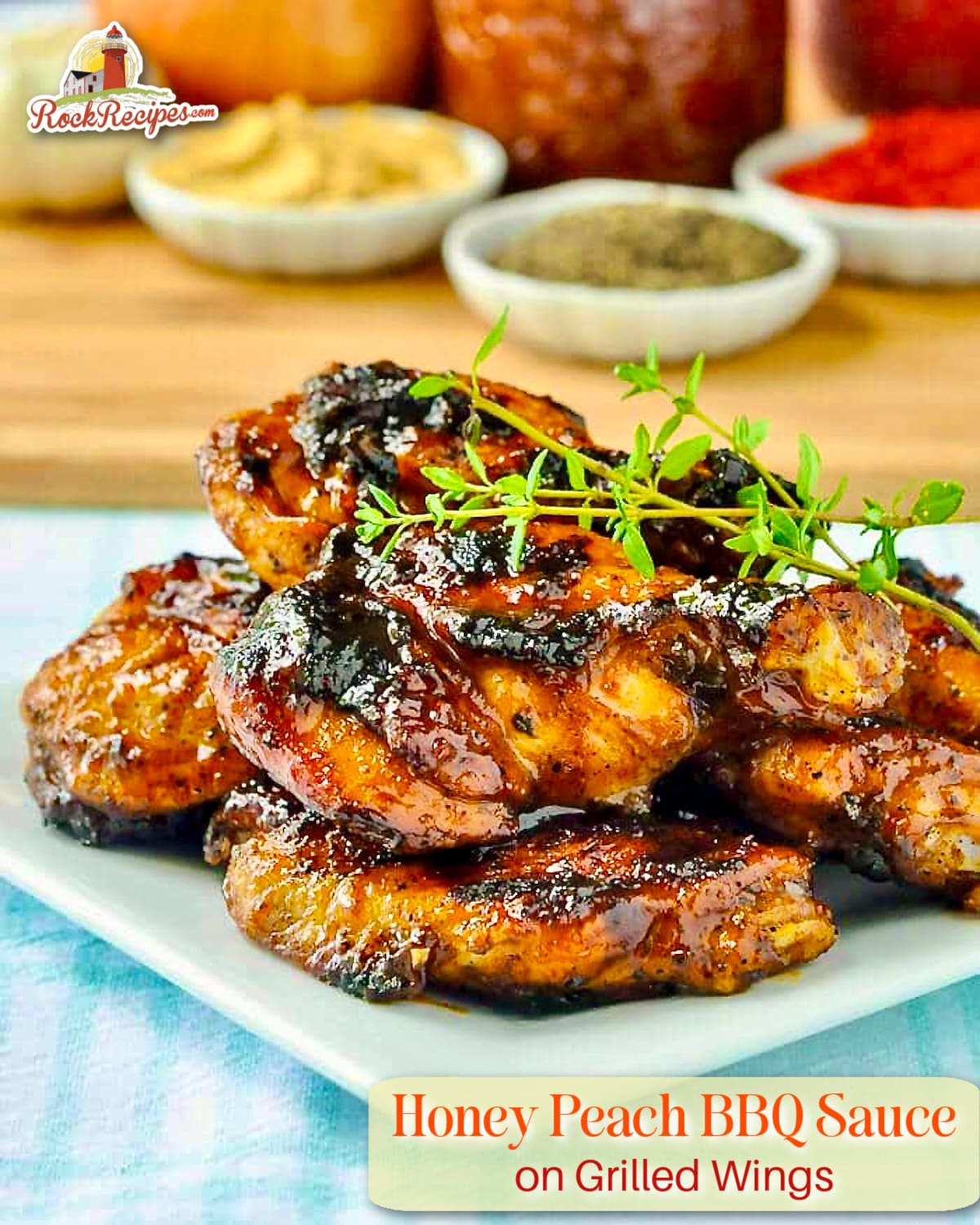 Photo of Honey Peach Barbecue Sauce on Grilled Wings with recipe ingredients in th background and title text added for Pinterest and social media posts.