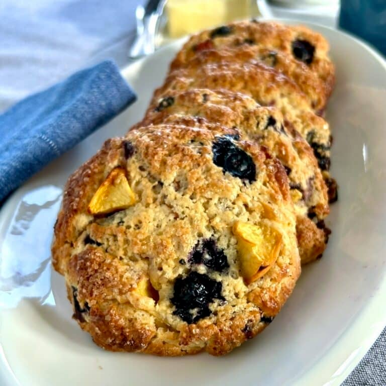 Blueberry Peach Coconut Scones close up photo of scones on a white plate.